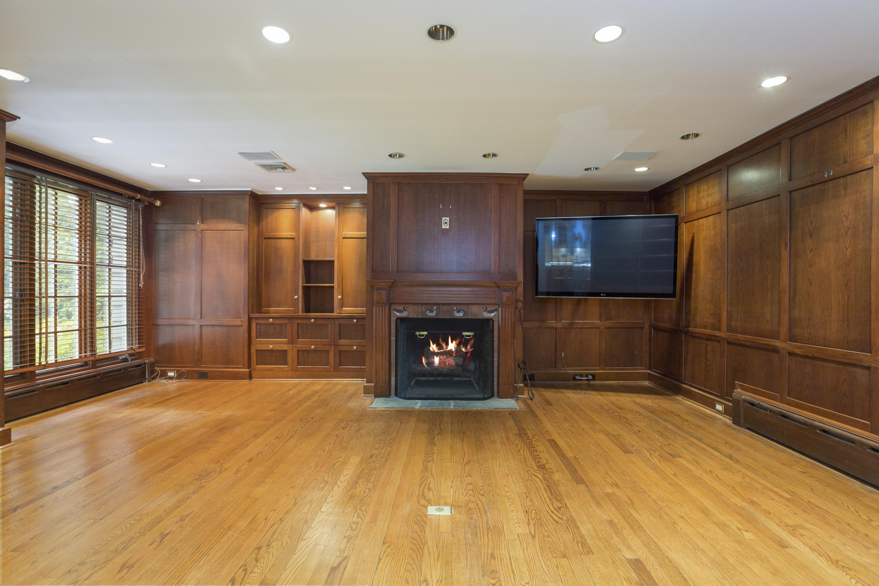 283 Hollow Tree Ridge Road Darien, CT 06820 - Photo 21 of 49 a view of an empty room with a fireplace and a window