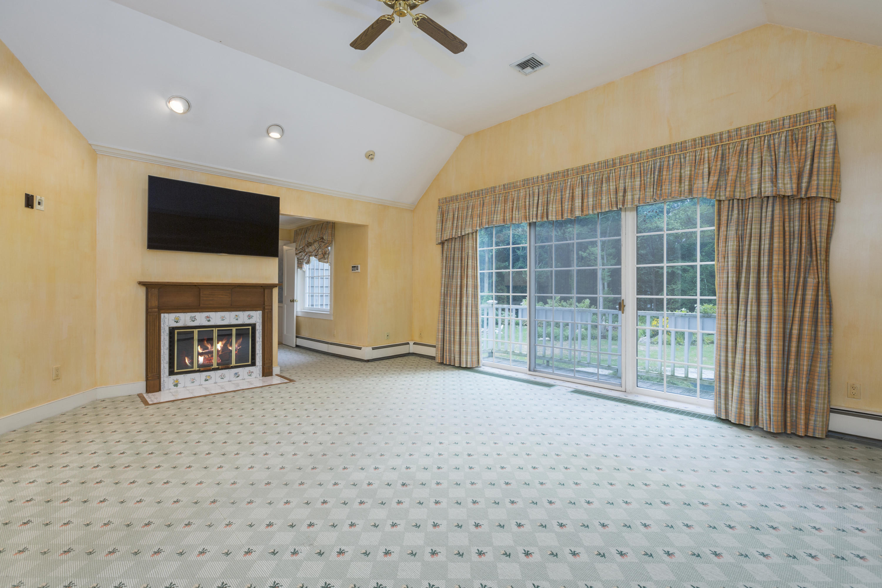 283 Hollow Tree Ridge Road Darien, CT 06820 - Photo 23 of 49 a view of an empty room with a fireplace and a window