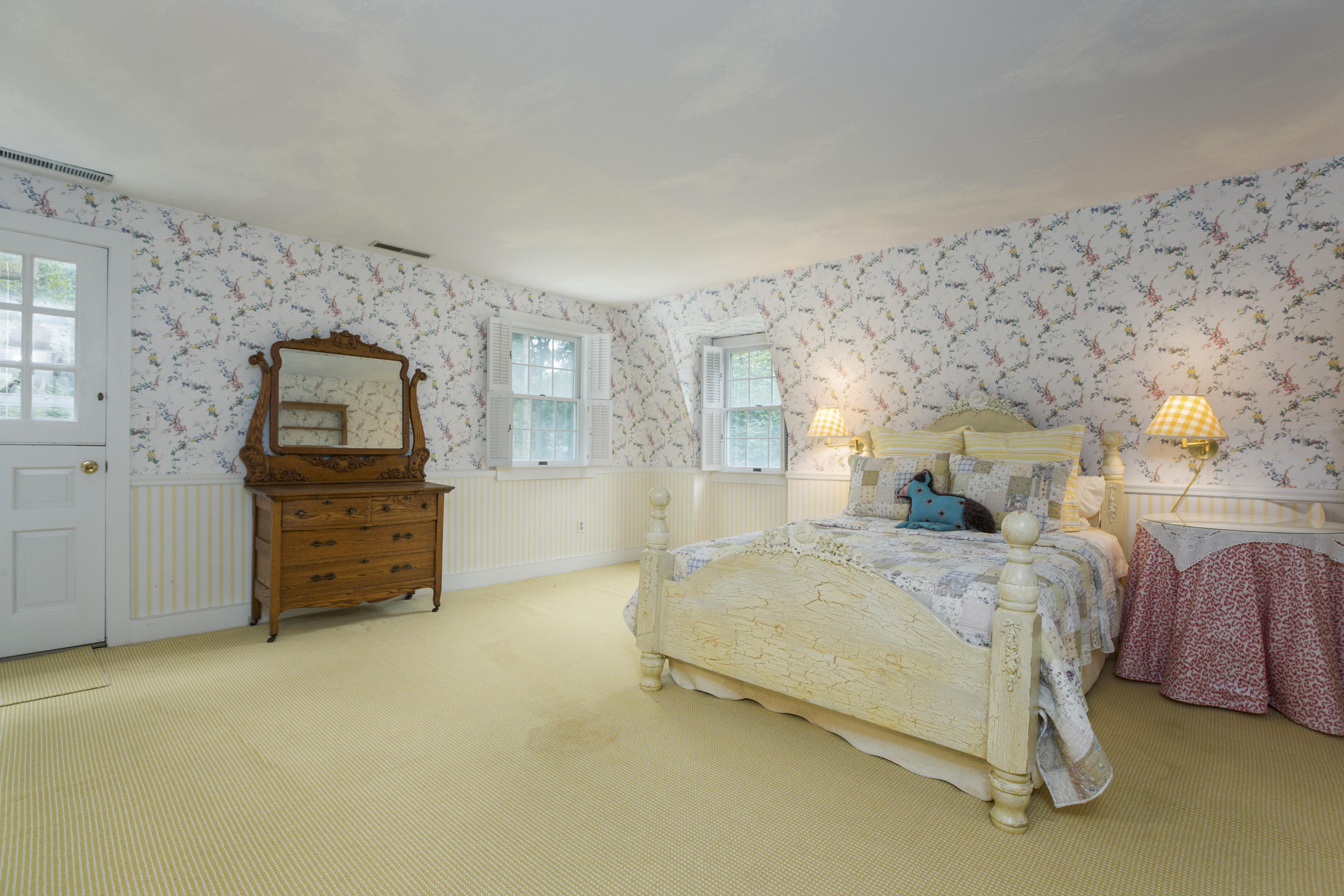 283 Hollow Tree Ridge Road Darien, CT 06820 - Photo 28 of 49 a spacious bedroom with a bed and a dresser