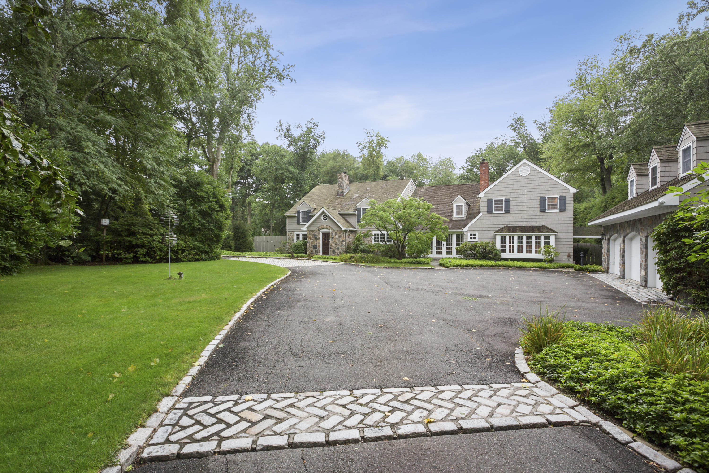 283 Hollow Tree Ridge Road Darien, CT 06820 - Photo 3 of 49 a front view of a house with a yard and garage