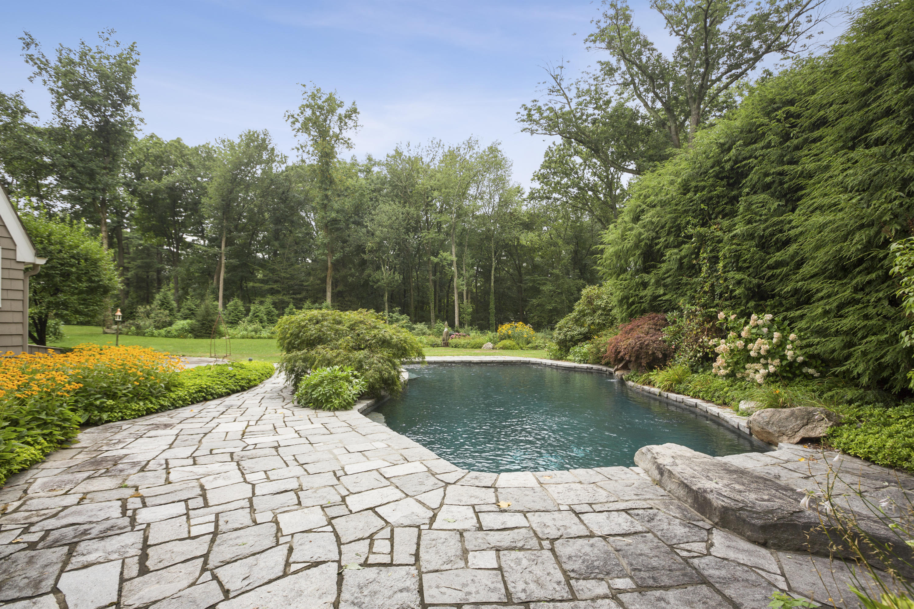 283 Hollow Tree Ridge Road Darien, CT 06820 - Photo 38 of 49 a view of a garden with a fountain