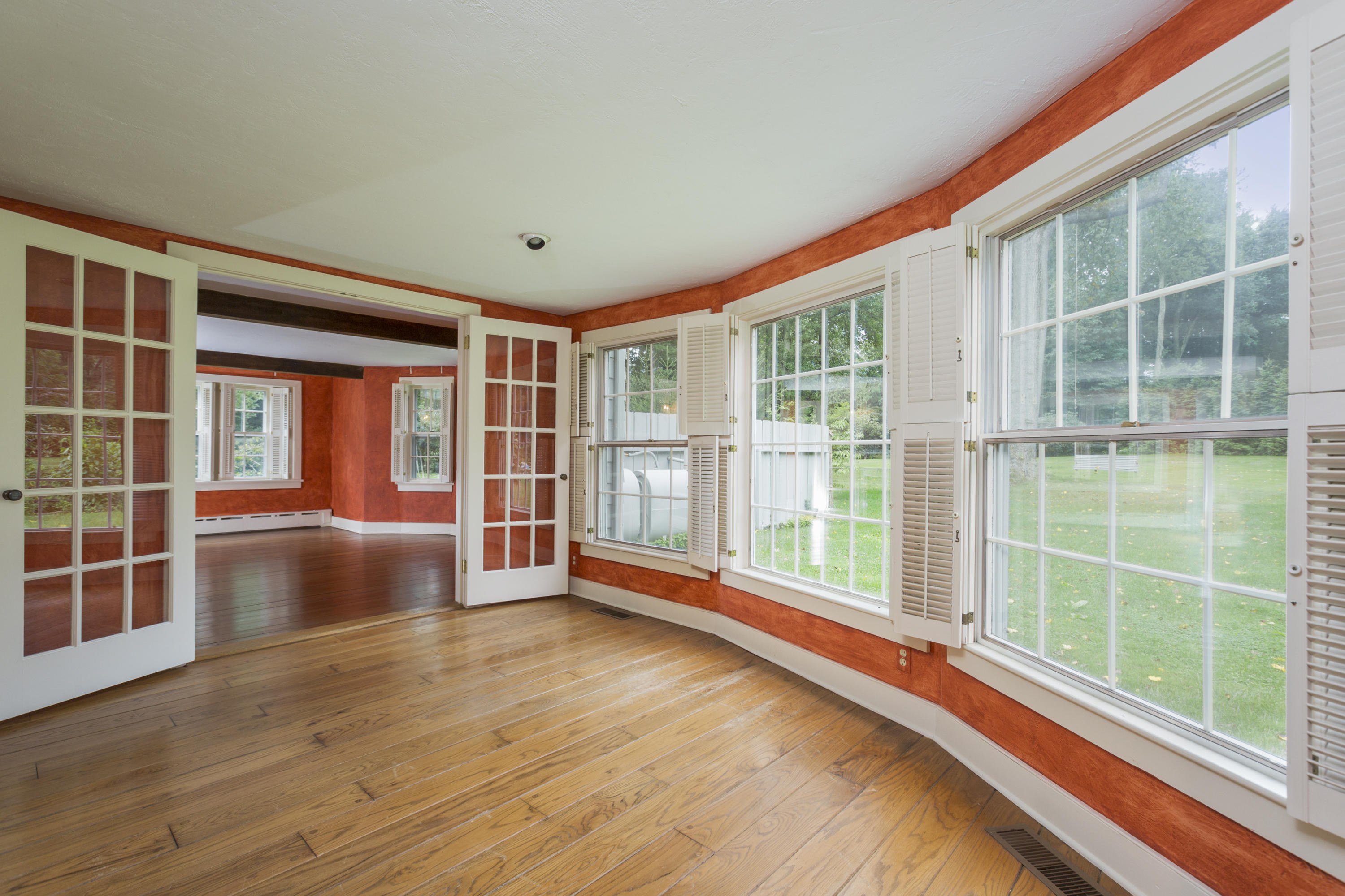 283 Hollow Tree Ridge Road Darien, CT 06820 - Photo 5 of 49 a view of empty room with wooden floor and windows