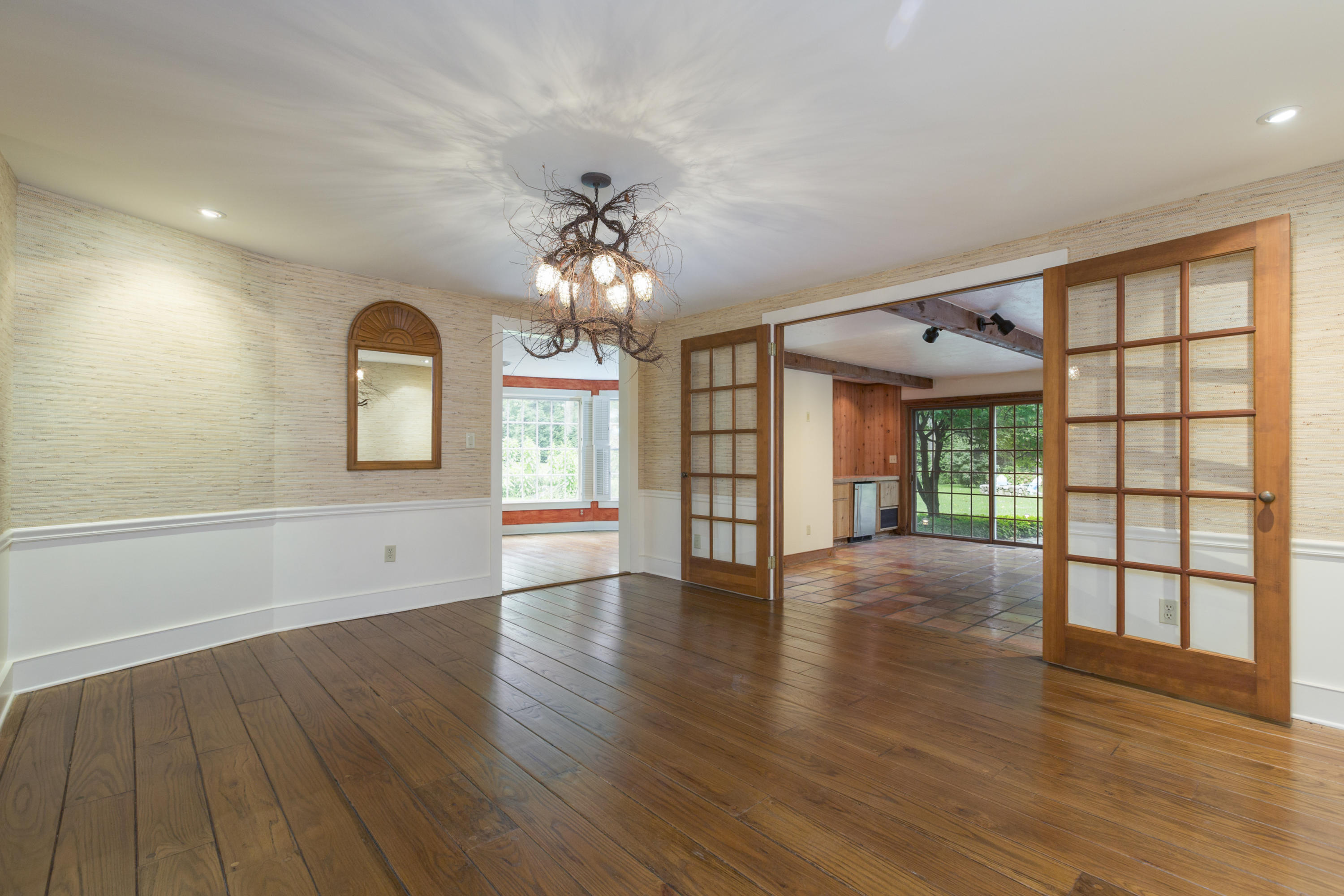 283 Hollow Tree Ridge Road Darien, CT 06820 - Photo 8 of 49 a view of an empty room with wooden floor and a window