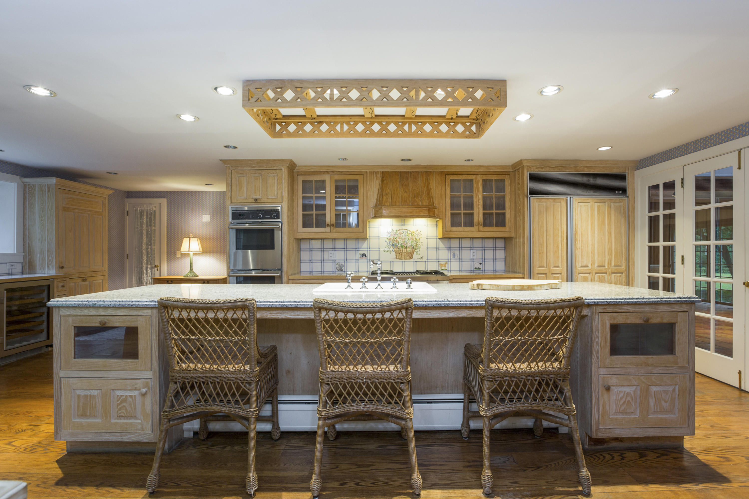 283 Hollow Tree Ridge Road Darien, CT 06820 - Photo 10 of 49 a kitchen with kitchen island granite countertop a table and chairs in it