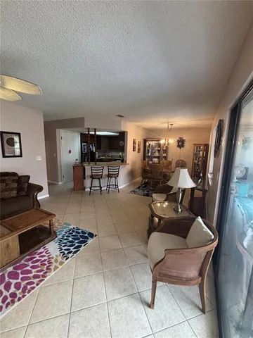 a living room with furniture a rug and a table