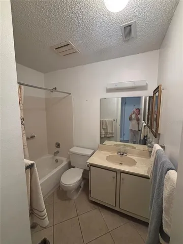 a spacious bathroom with a sink toilet and shower