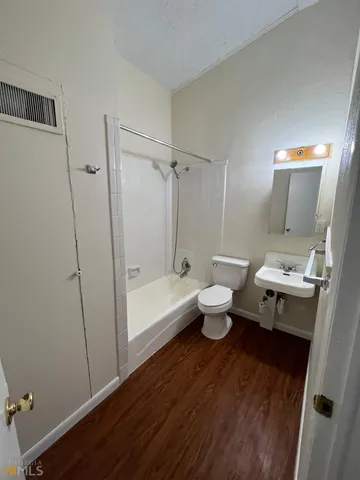 a bathroom with a toilet sink and shower