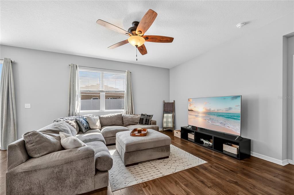 4368 Moon Shadow Loop Mulberry, FL 33860 - Photo 15 of 39 a living room with furniture and a flat screen tv