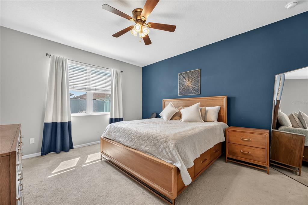 4368 Moon Shadow Loop Mulberry, FL 33860 - Photo 16 of 39 a bed room with a bed and a ceiling fan