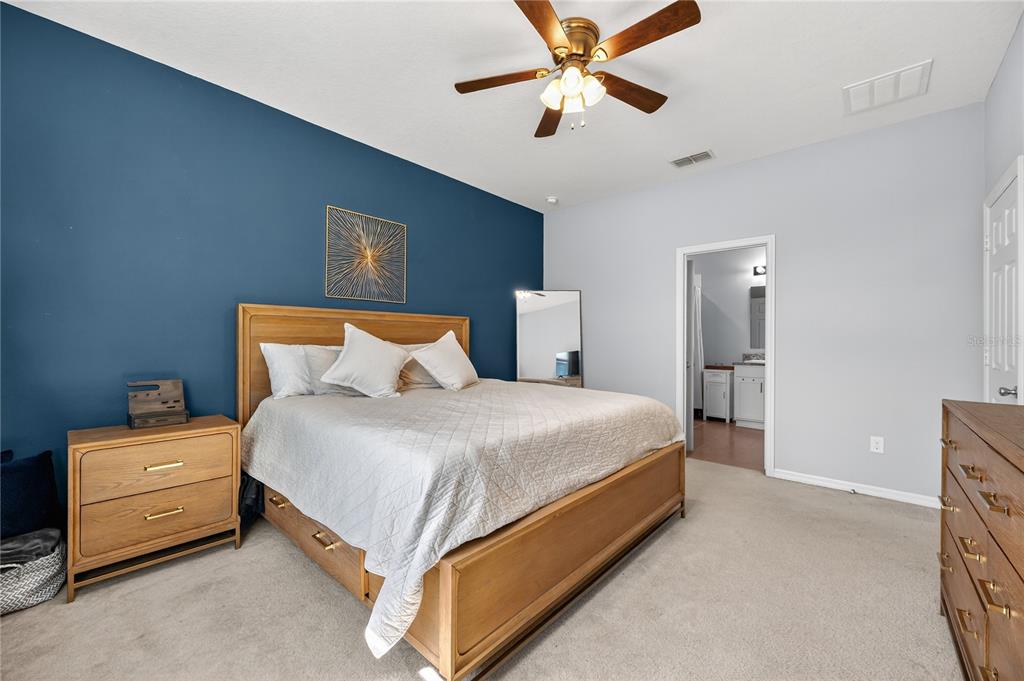 4368 Moon Shadow Loop Mulberry, FL 33860 - Photo 17 of 39 a bedroom with a bed and a ceiling fan