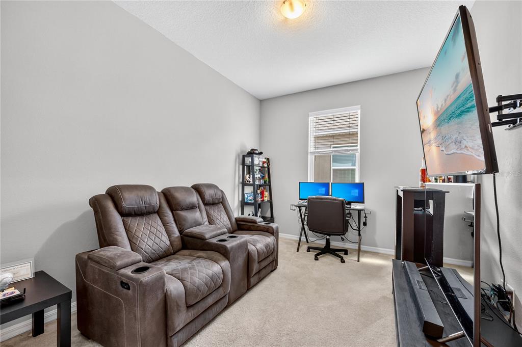 4368 Moon Shadow Loop Mulberry, FL 33860 - Photo 23 of 39 a living room with furniture a window and a flat screen tv