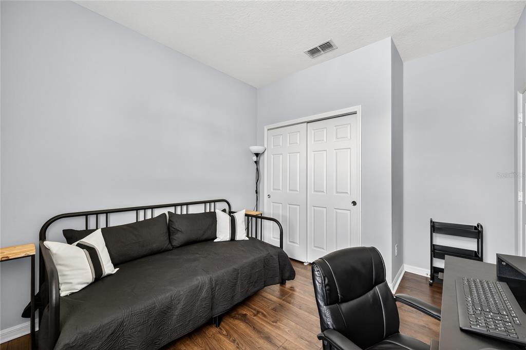 4368 Moon Shadow Loop Mulberry, FL 33860 - Photo 26 of 39 a bedroom with furniture and wooden floor