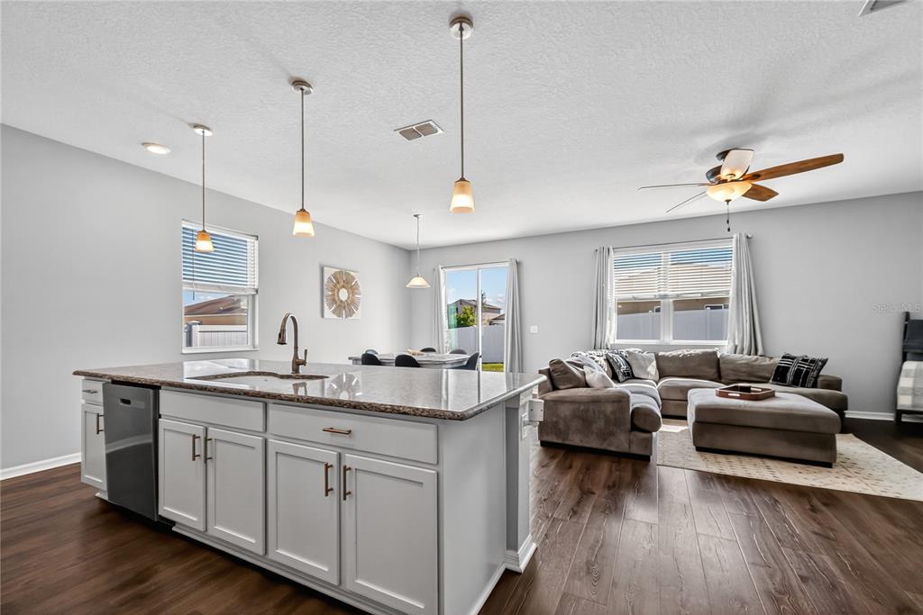4368 Moon Shadow Loop Mulberry, FL 33860 - Photo 9 of 39 a view of a kitchen counter kitchen island furniture with wooden floor