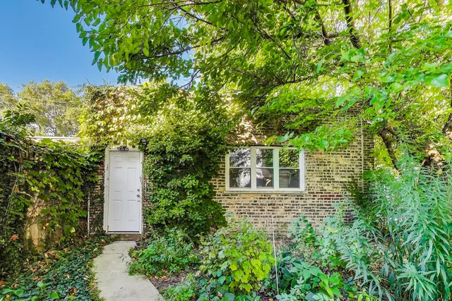 front view of a house with a tree