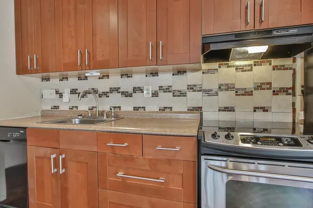 a kitchen with granite countertop a sink and cabinets