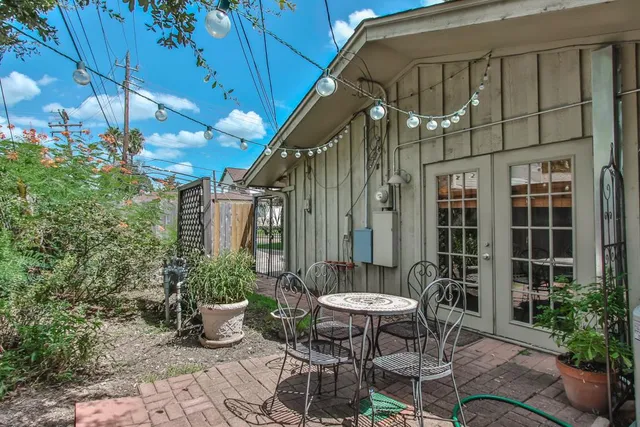 a backyard of a house with table and chairs