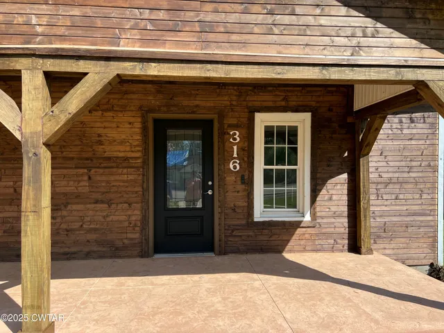 a front view of a house with a door and a window