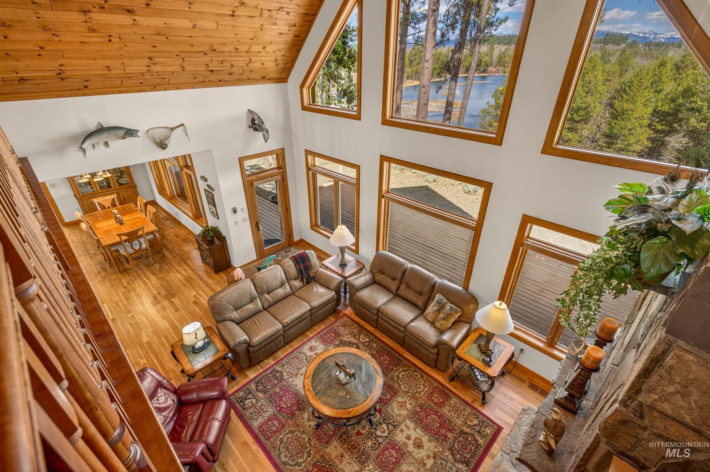 8 Bitterroot Court McCall, ID 83638 - Photo 27 of 50 Living room featuring hardwood / wood-style floors, a water view, and vaulted ceiling