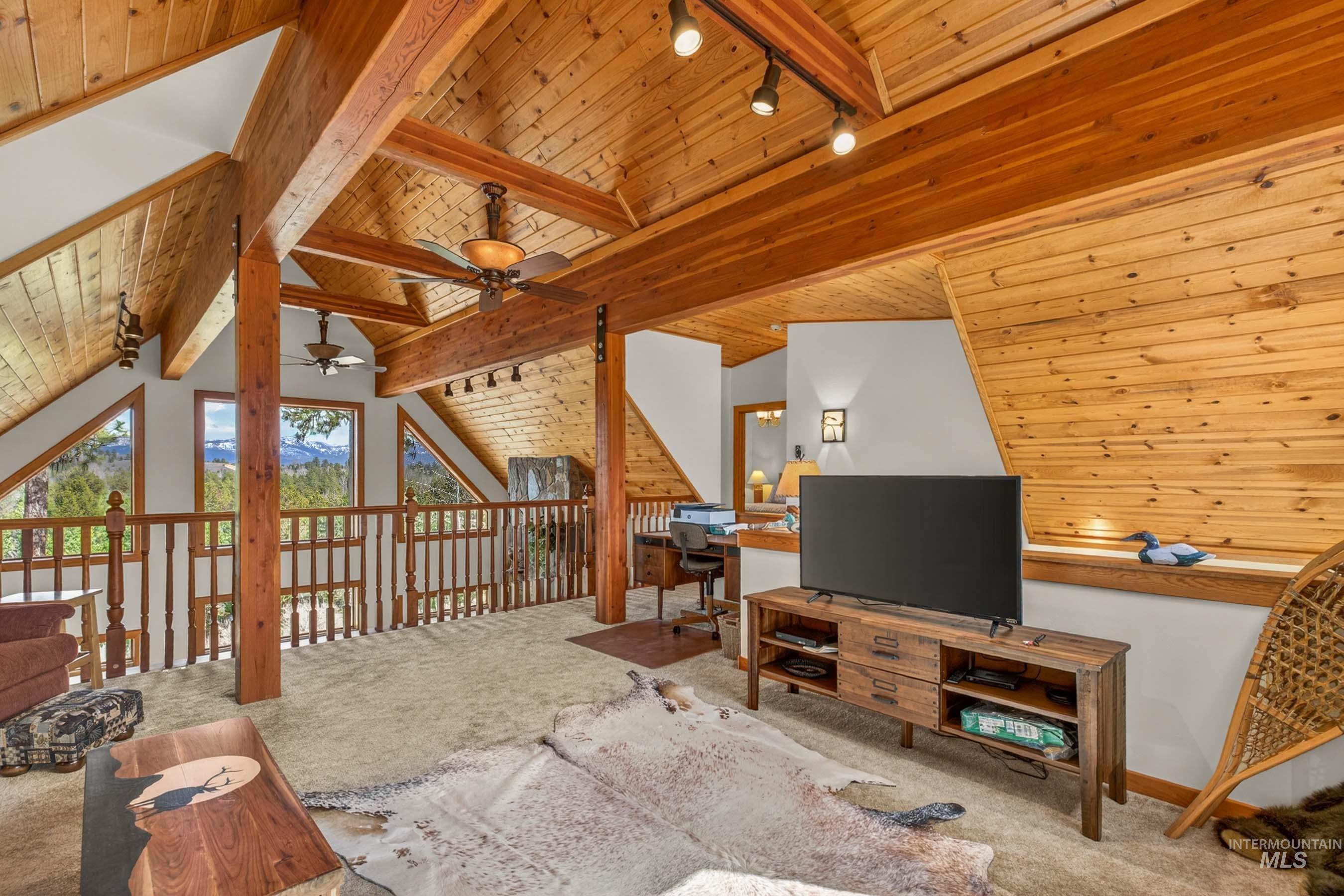 8 Bitterroot Court McCall, ID 83638 - Photo 29 of 50 Carpeted living area featuring wood ceiling, track lighting, and lofted ceiling with beams