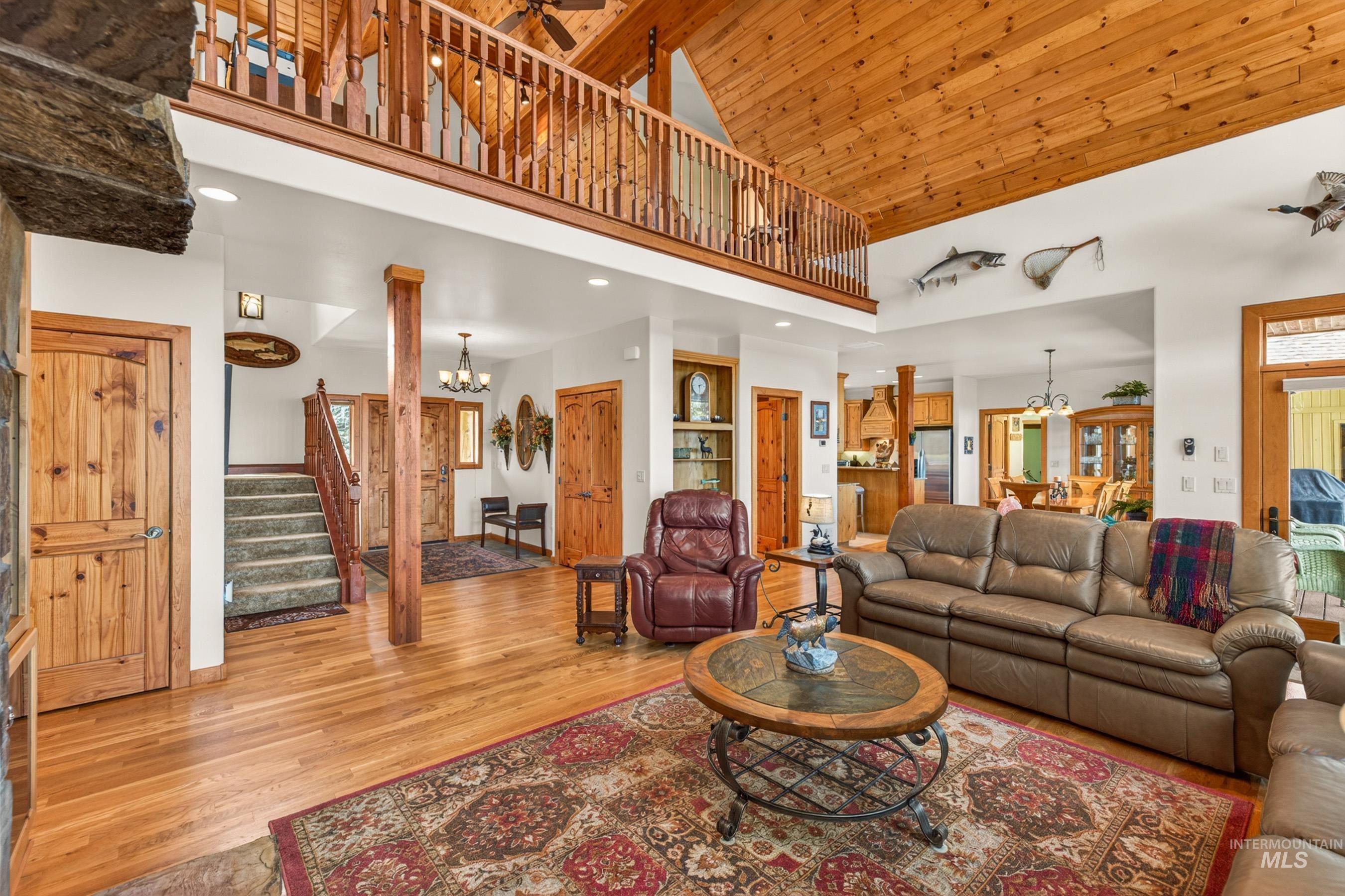 8 Bitterroot Court McCall, ID 83638 - Photo 7 of 50 Living area featuring hanging lights, wood finished floors, and a high wooden ceiling