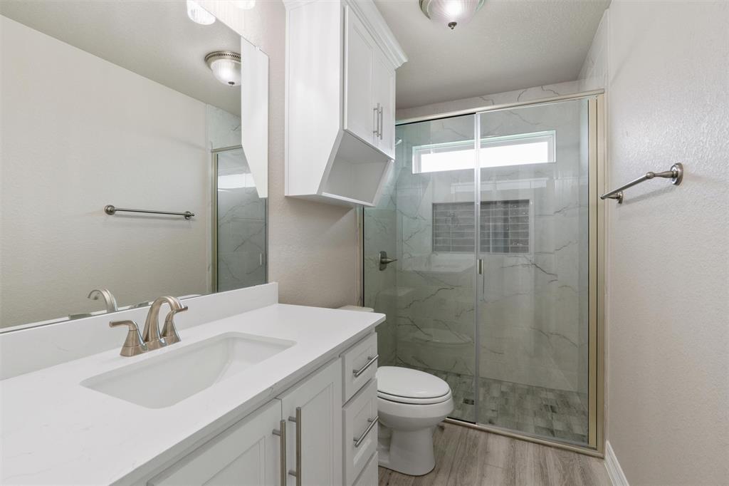 1341 Promised Land Road Hewitt, TX 76643 - Photo 22 of 29 Bathroom featuring a single vanity with white cabinetry, a rectangular undermount sink, and a brushed nickel faucet