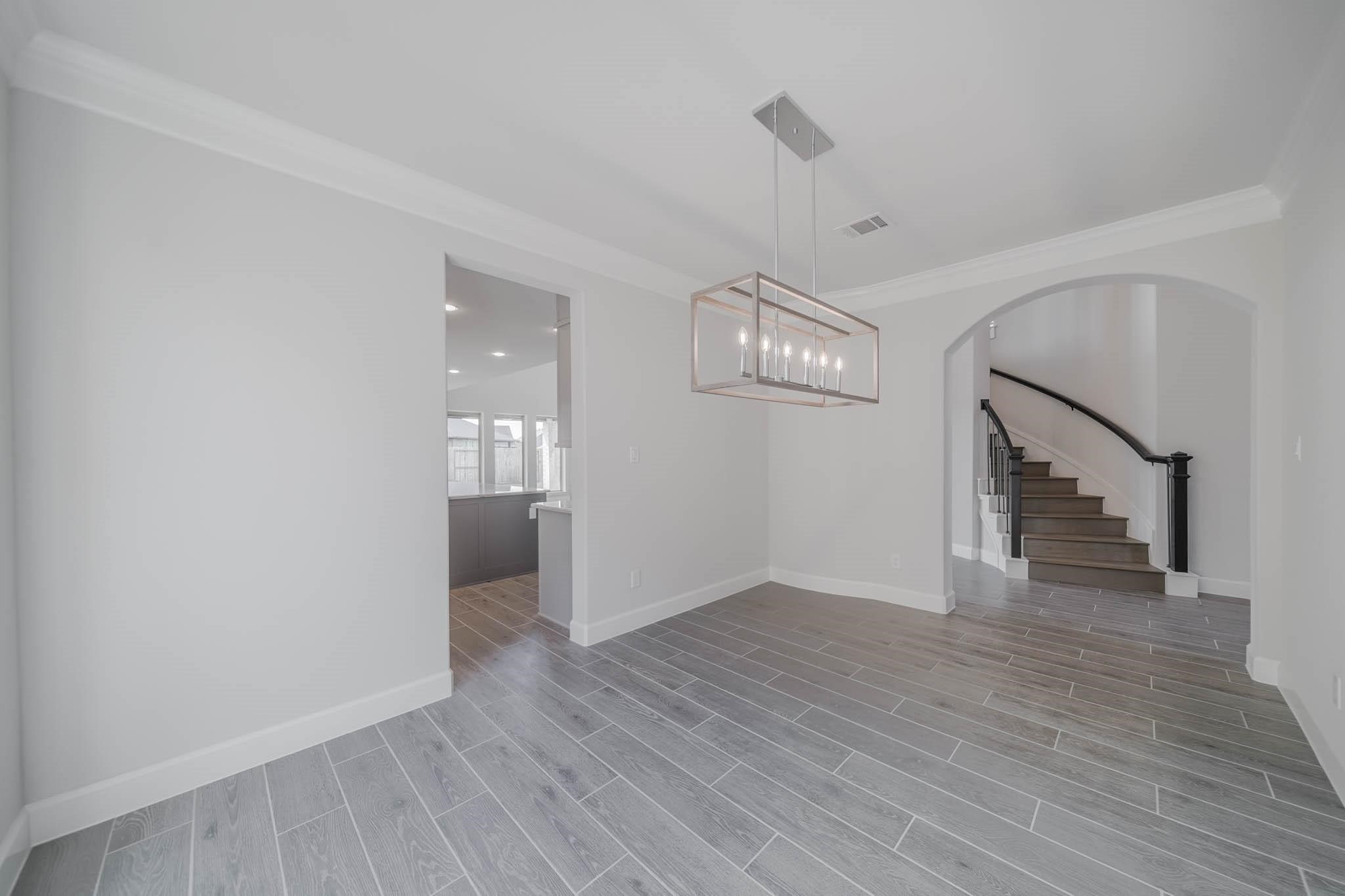 29103 Hauter Way Fulshear, TX 77441 - Photo 16 of 40 a view of empty room with wooden floor