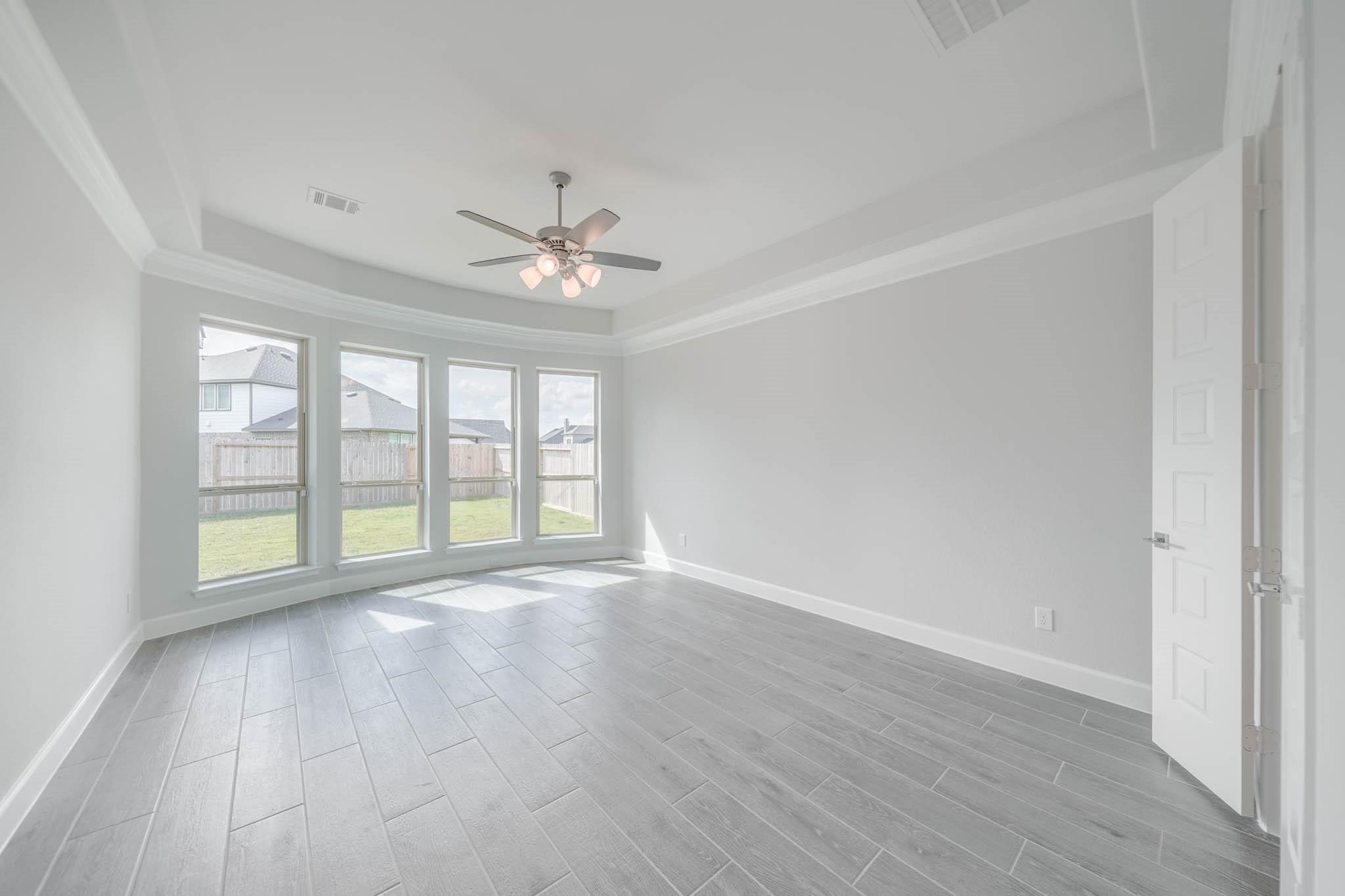 29103 Hauter Way Fulshear, TX 77441 - Photo 24 of 40 a view of an empty room with a window and wooden floor