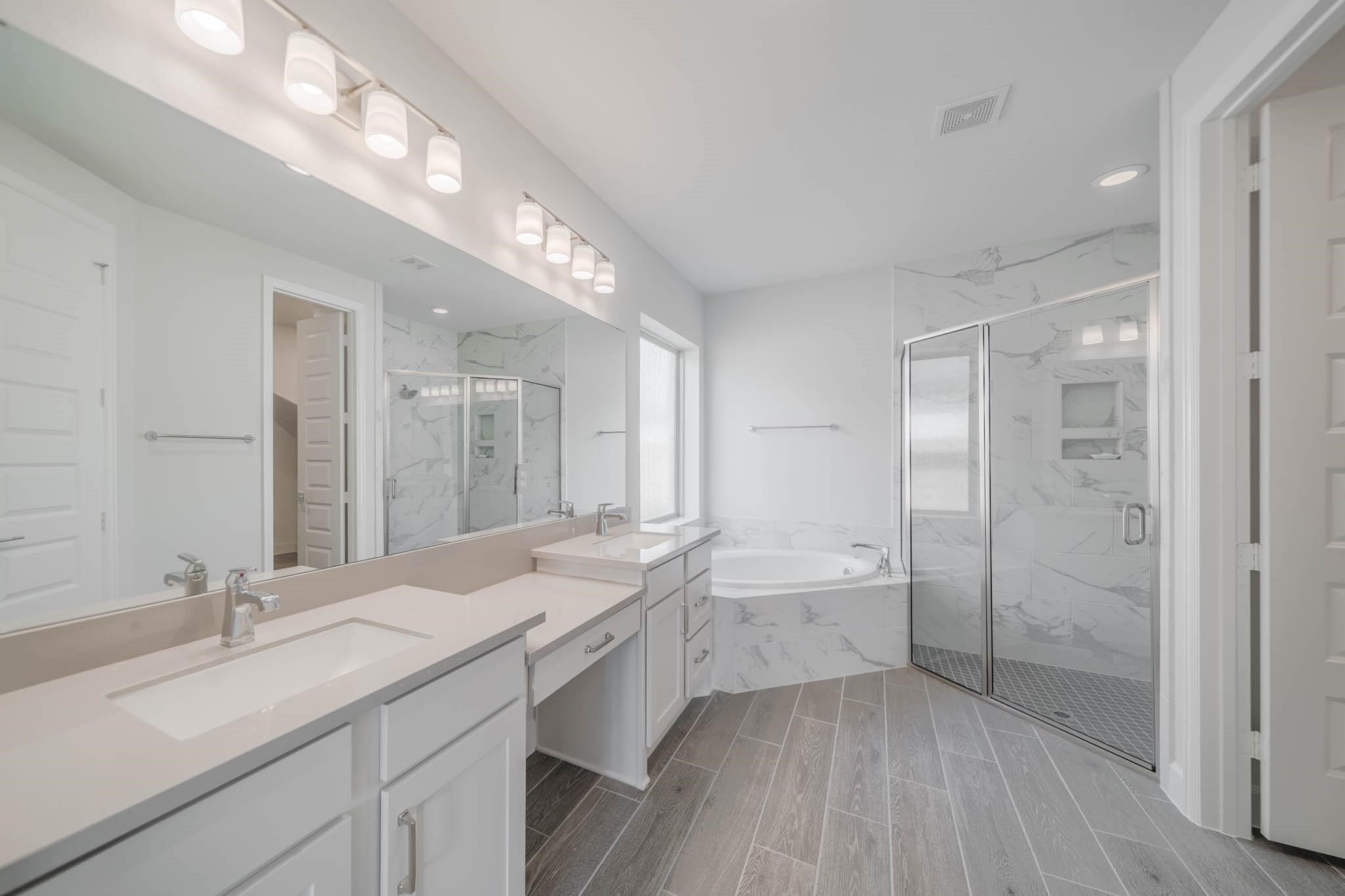 29103 Hauter Way Fulshear, TX 77441 - Photo 26 of 40 a bathroom with a double vanity sink a toilet and a shower