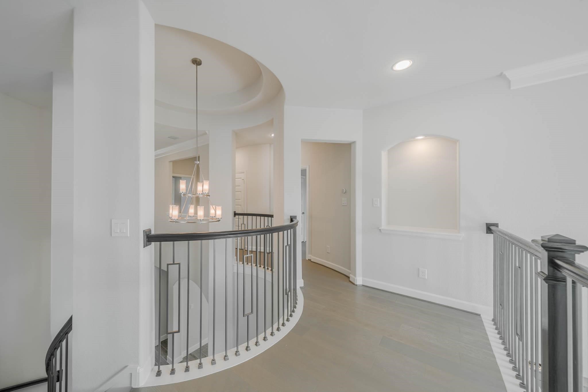 29103 Hauter Way Fulshear, TX 77441 - Photo 28 of 40 a view of staircase with white walls and railing