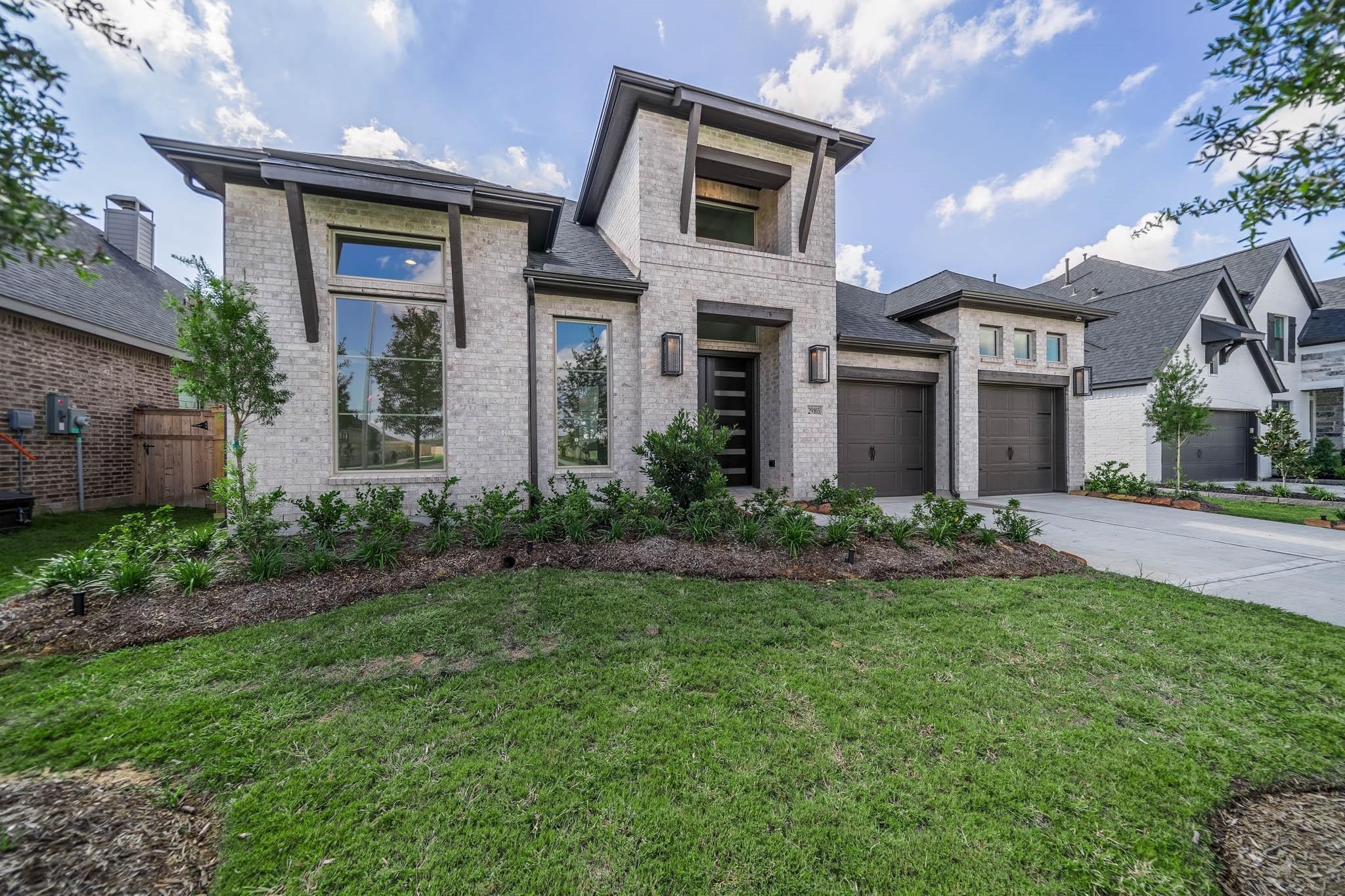 29103 Hauter Way Fulshear, TX 77441 - Photo 3 of 40 a front view of a residential houses with yard and green space