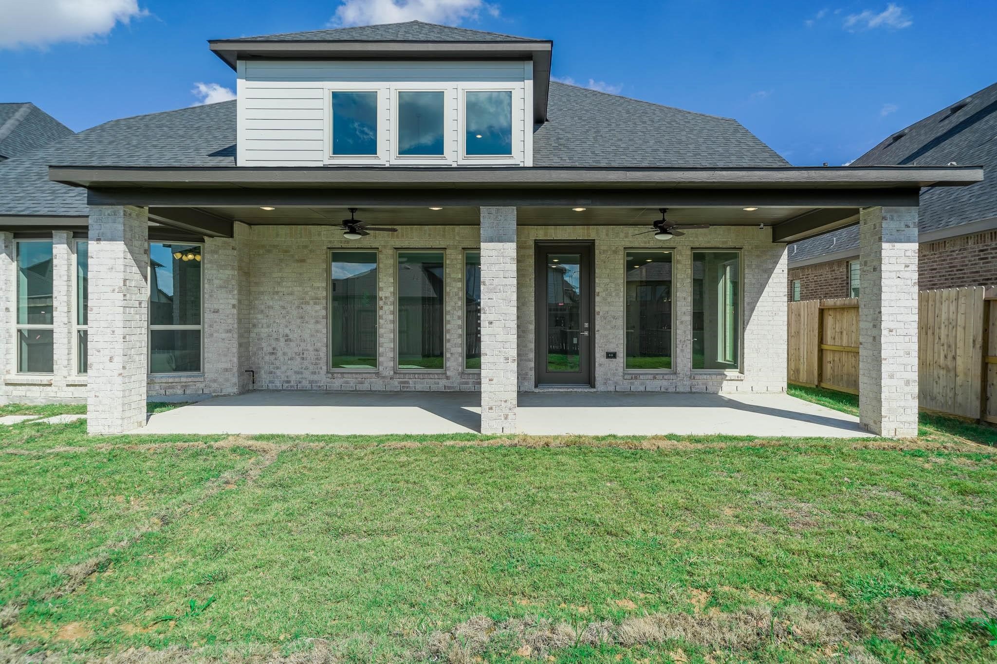 29103 Hauter Way Fulshear, TX 77441 - Photo 37 of 40 front view of a brick house with a yard