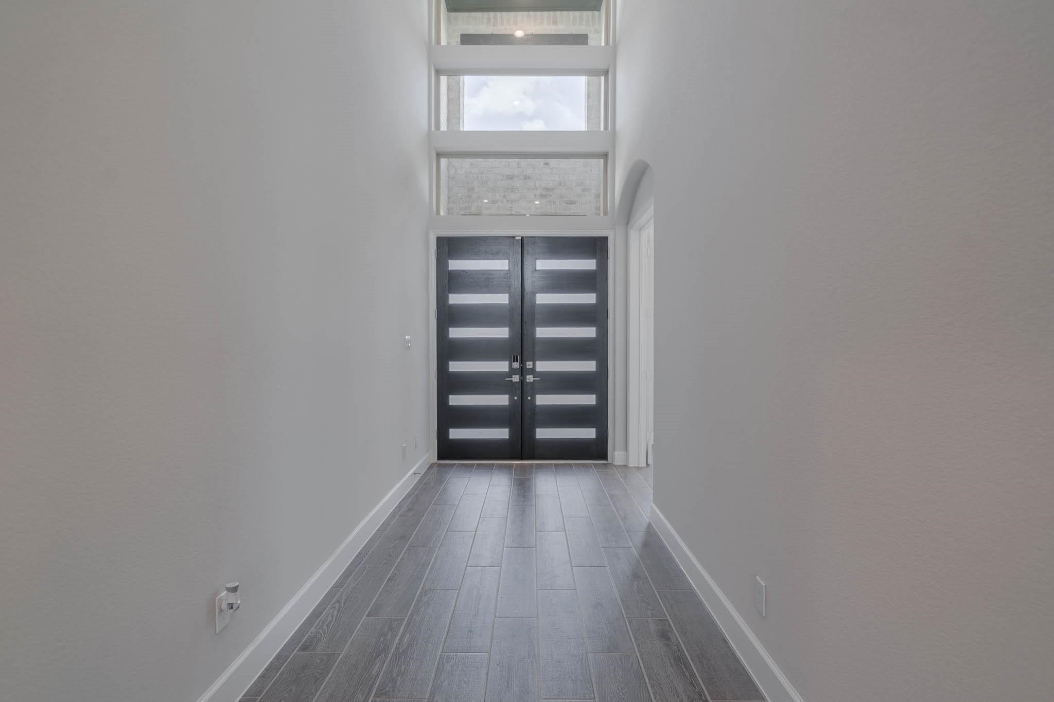 29103 Hauter Way Fulshear, TX 77441 - Photo 6 of 40 a view of an empty room with wooden floor and a window