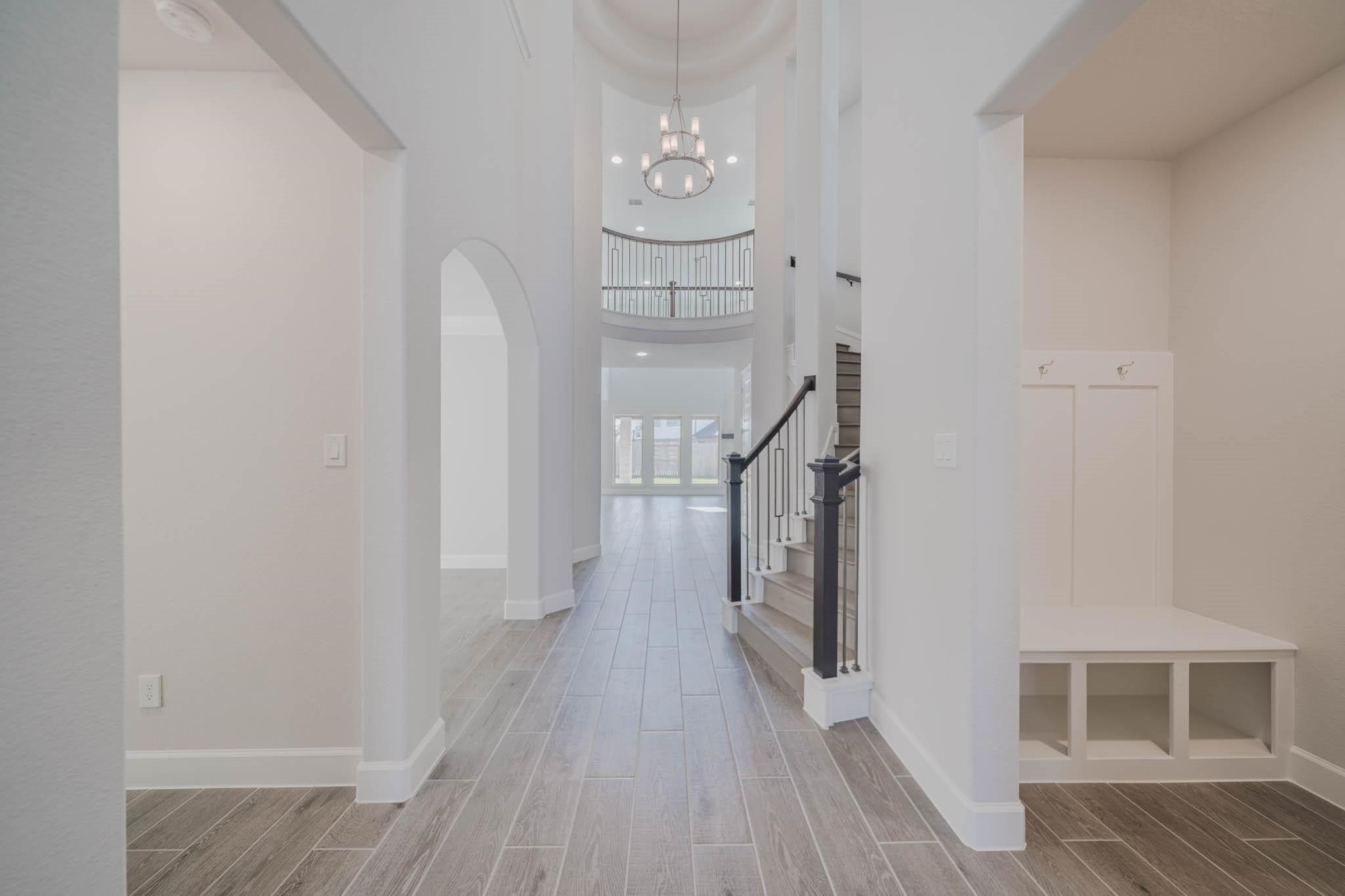 29103 Hauter Way Fulshear, TX 77441 - Photo 7 of 40 a view of a hallway with wooden floor and staircase