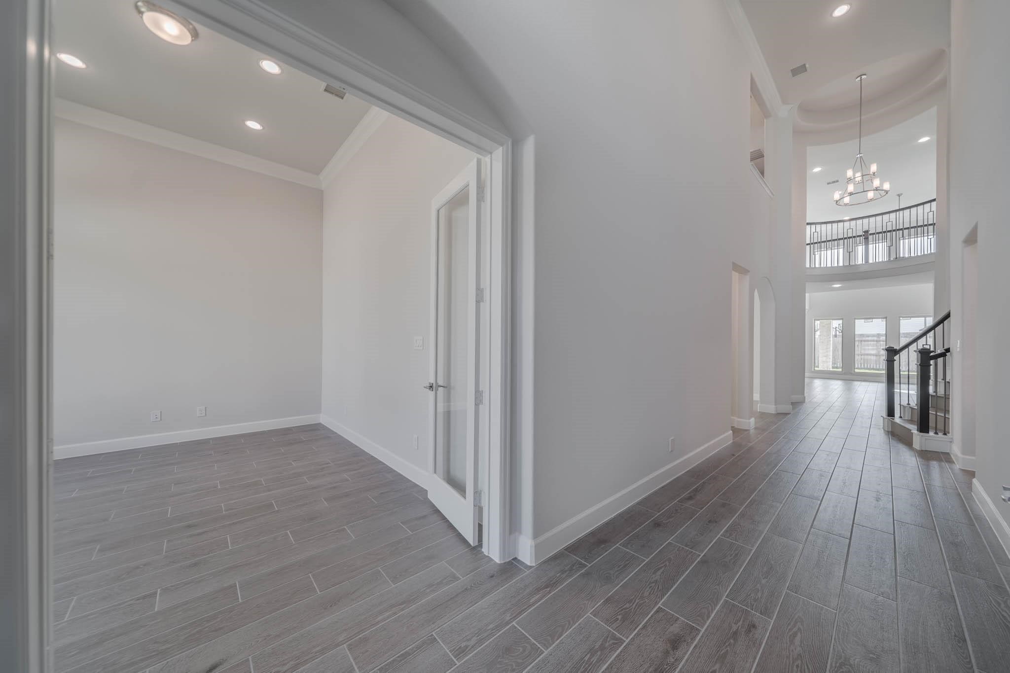 29103 Hauter Way Fulshear, TX 77441 - Photo 8 of 40 a view of a hallway with wooden floor