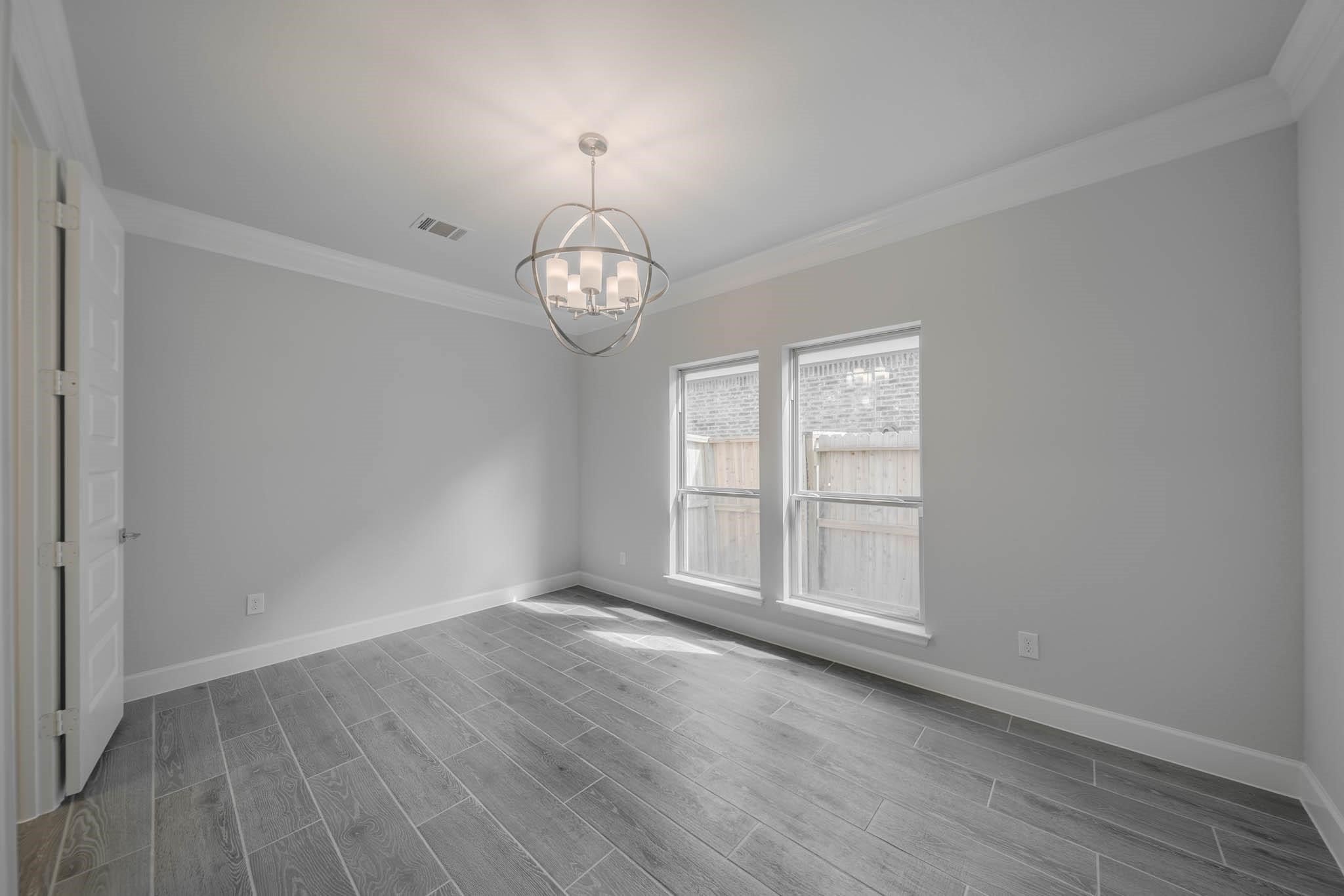 29103 Hauter Way Fulshear, TX 77441 - Photo 10 of 40 an empty room with wooden floor and windows
