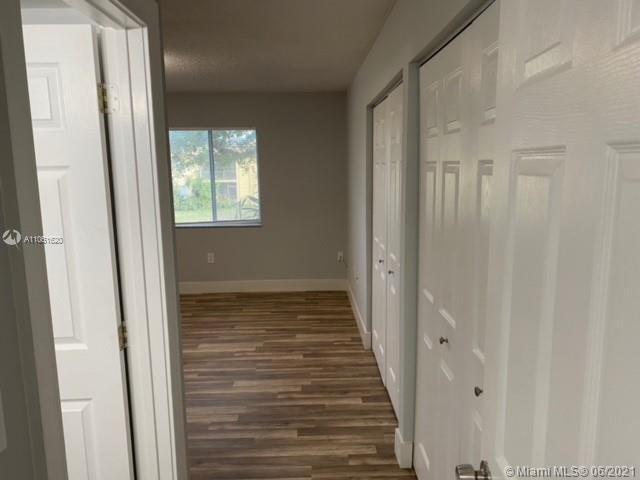 842 Southwest 9th St Circle, Unit 202 Boca Raton, FL 33486 - Photo 7 of 27 a view of a hallway with wooden floor and entryway