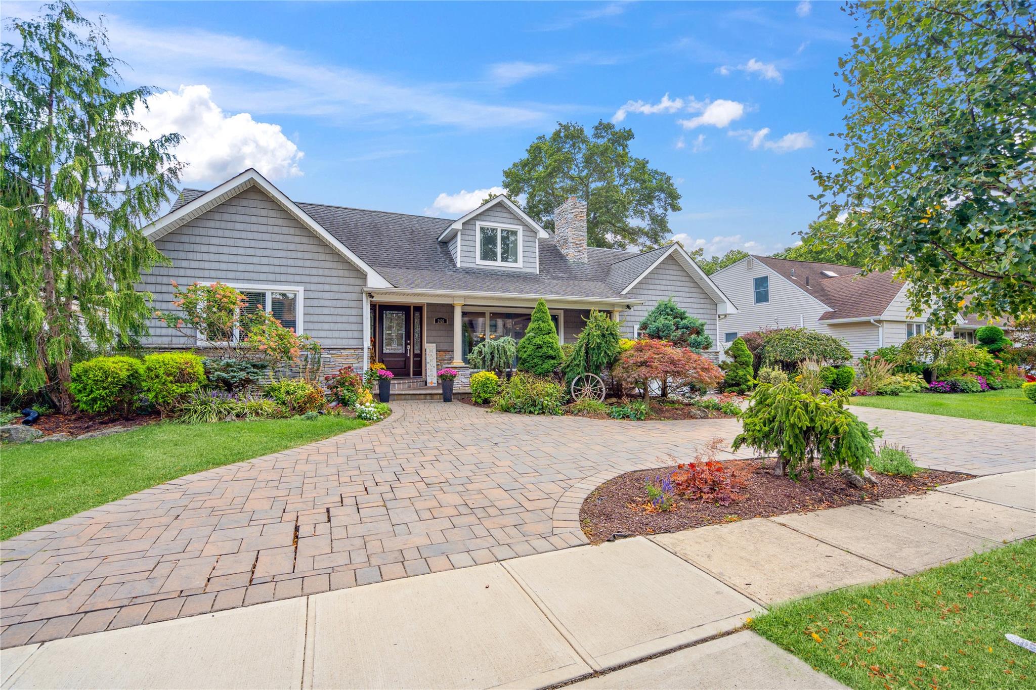 2126 Cayuga Drive Merrick, NY 11566 - Photo 1 of 1 a front view of a house with a yard and potted plants
