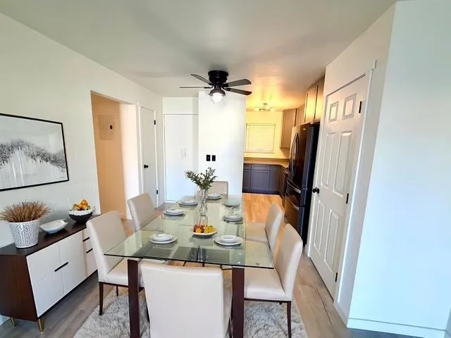a view of a dining room with furniture and a mirror
