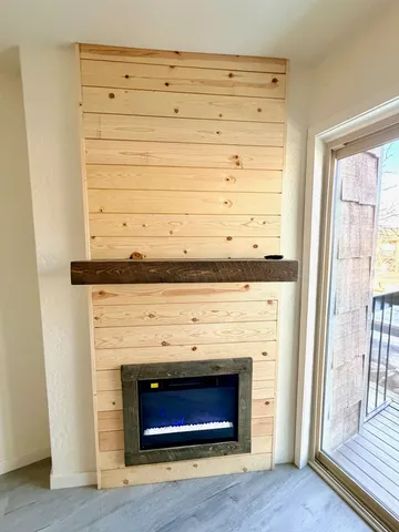 a living room with a fireplace and a fireplace