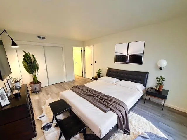 a bedroom with a bed and a chandelier