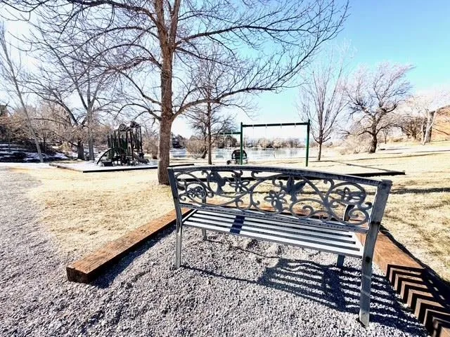a view of a roof deck with wooden fence and a couple of chairs