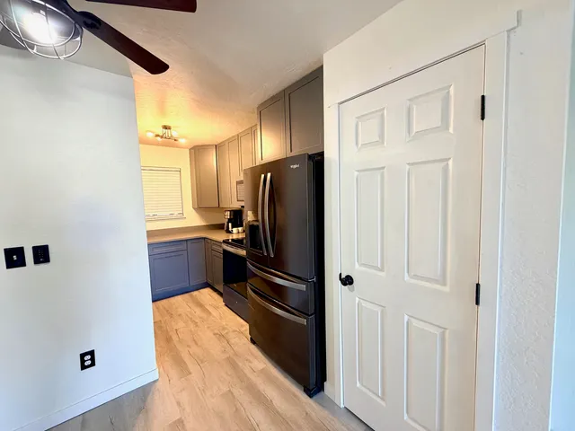a kitchen with stainless steel appliances a refrigerator and a cabinets