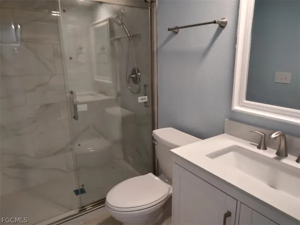 a white toilet sitting next to a bathroom sink