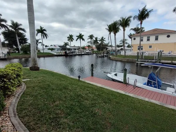 a view of a lake with a bench and trees