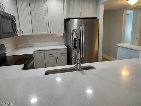 a kitchen with a refrigerator and cabinets