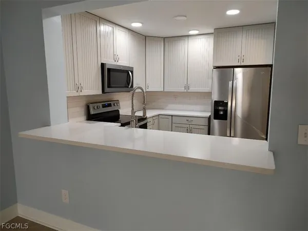 a kitchen with stainless steel appliances a refrigerator and a sink