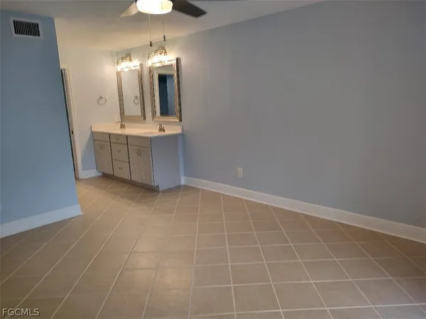 a bathroom with a sink a mirror and a shower
