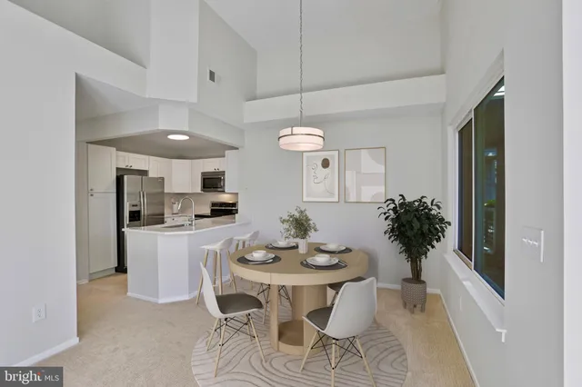 a kitchen with a dining table and chairs
