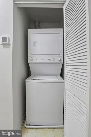 a view of a hallway with bathroom and front door