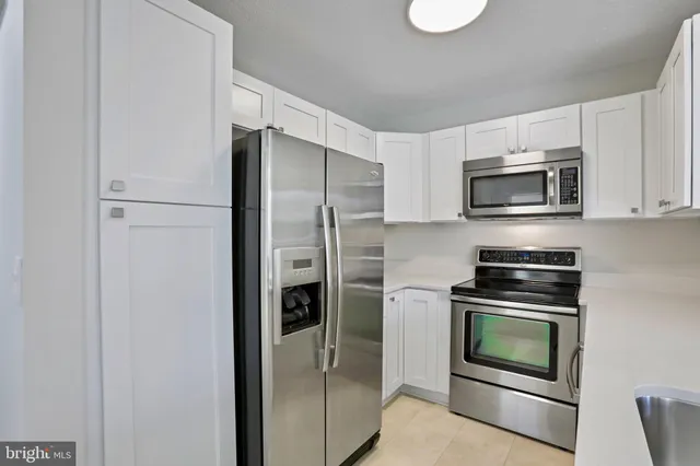 a kitchen with a refrigerator stove and microwave